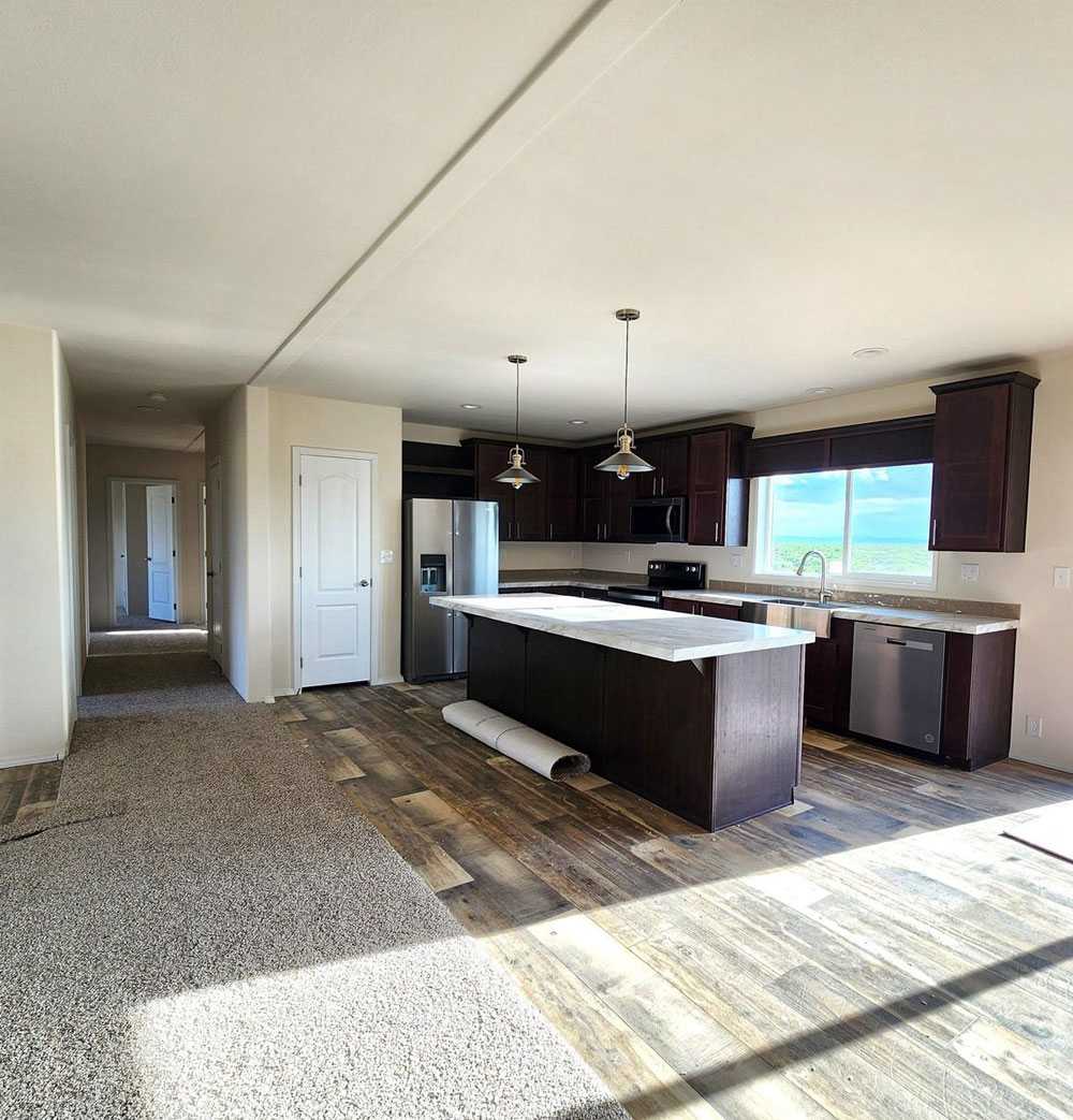 Modern kitchen with island in 28664E The Rapids