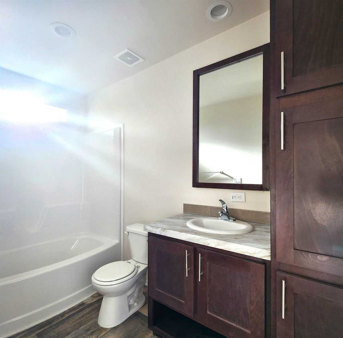 Well-appointed guest bathroom with lots of storage space and natural light.