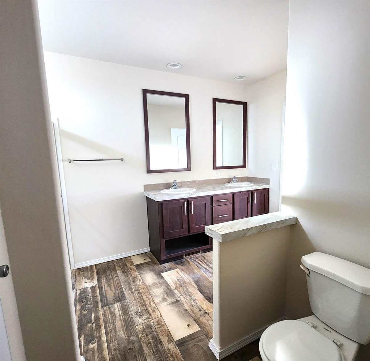 Private toilet and vanity in The Rapids primary bath.