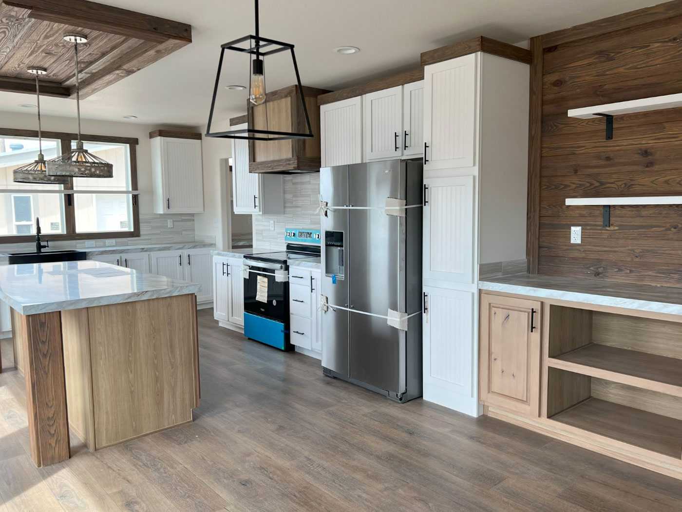Handcrafted cabinets and stylish black farmhouse sink in The Clover kitchen