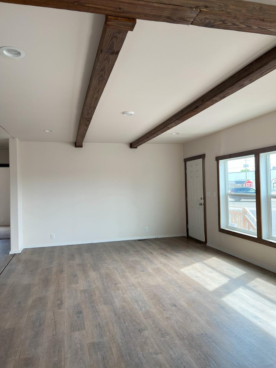 Bright, spacious living room with built-in entertainment center in The Clover