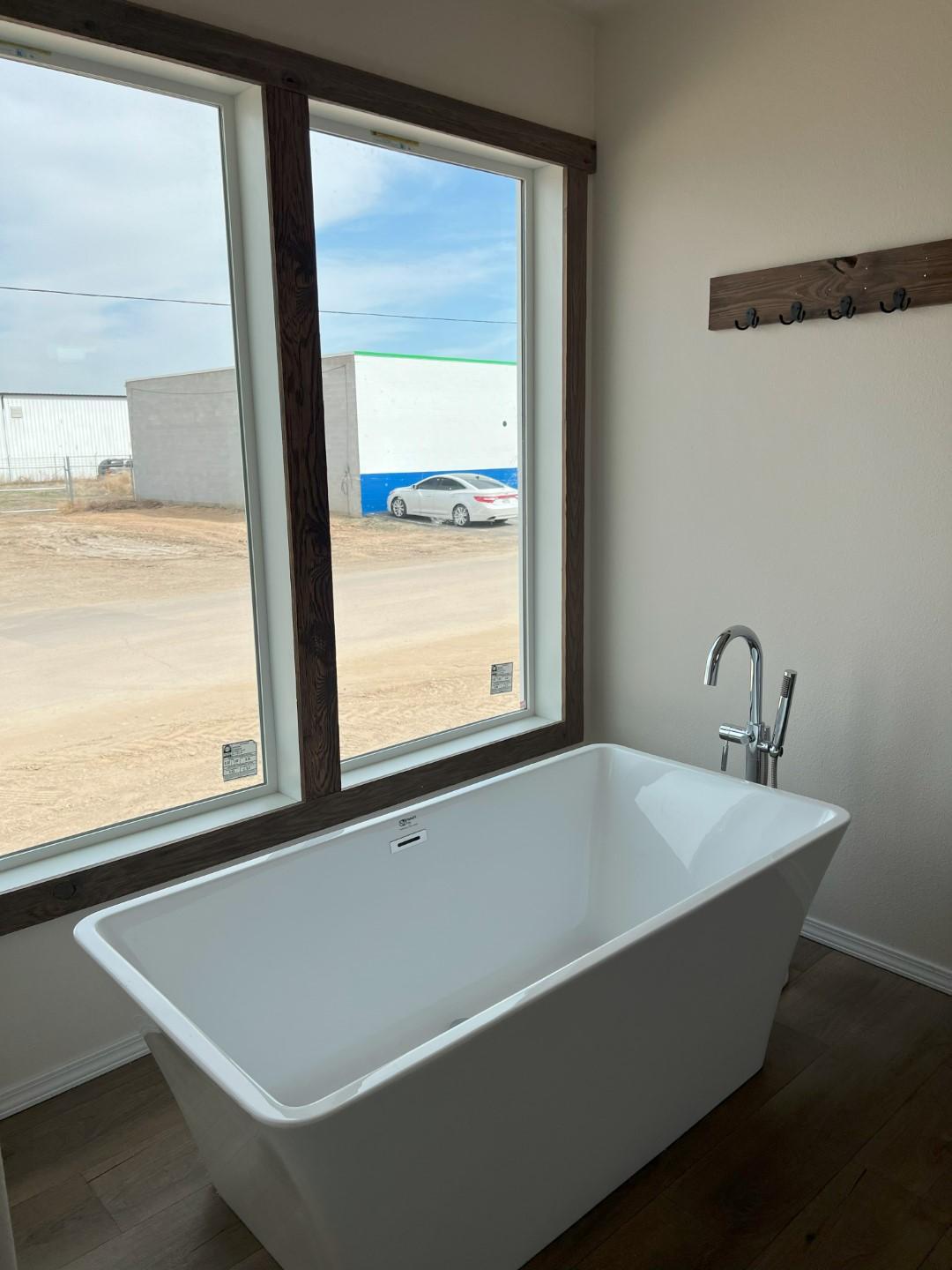 Master bedroom with freestanding soaking tub in The Clover by Fleetwood Homes.