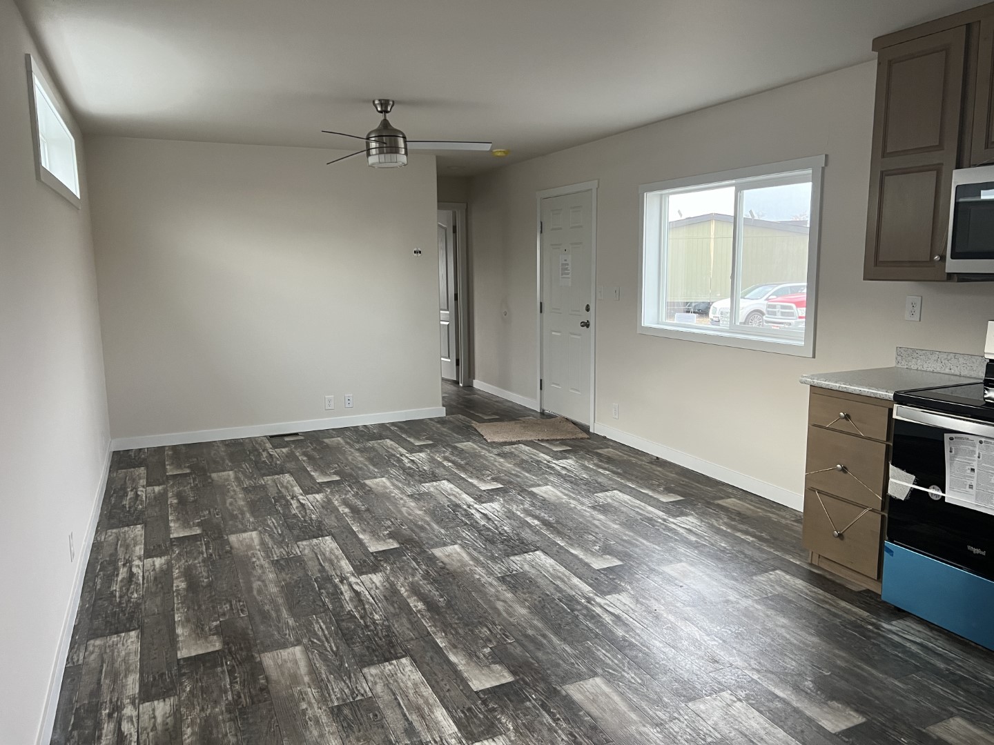 Open-concept living room with modern ceiling fan in the Legacy.