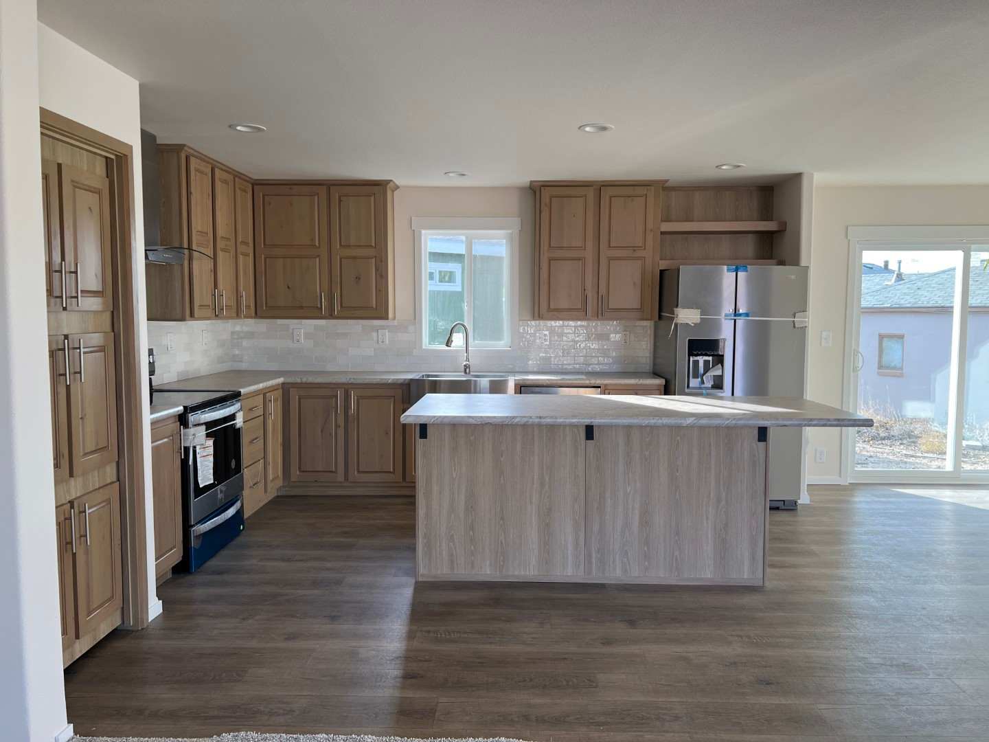 Modern kitchen with center island in The Sawtooth by Fleetwood Homes.