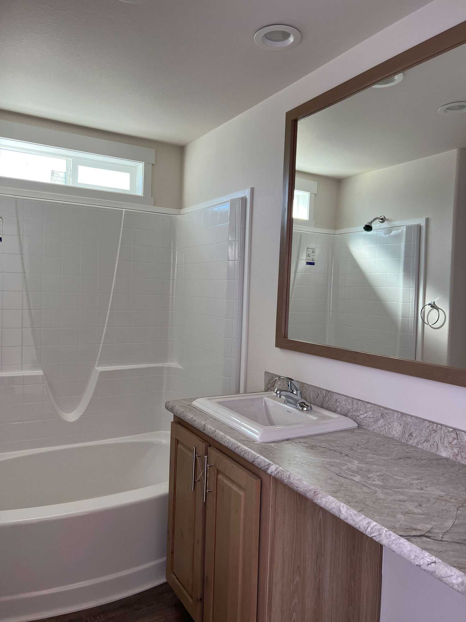 Spacious bathroom with oval tub adds luxury to The Sawtooth home
