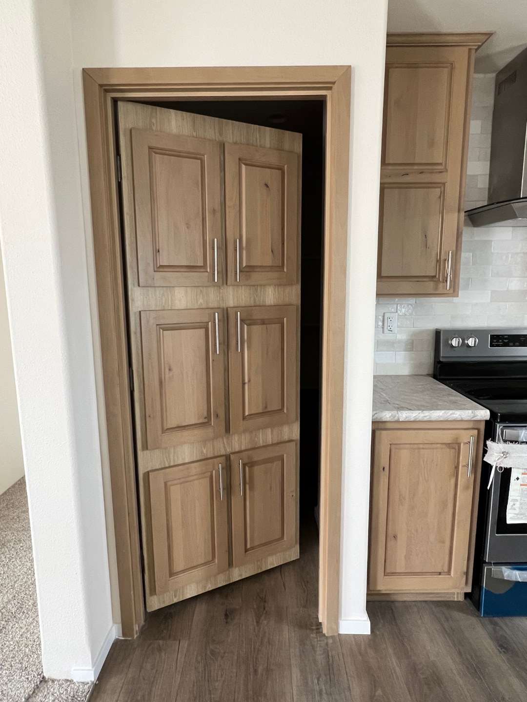 The Sawtooth’s hidden pantry offers ample storage space for your kitchen needs.