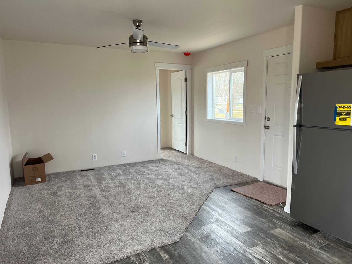 Functional living room with designer ceiling fan in this Fleetwood home