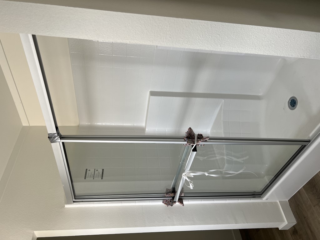 Walk-in shower in the Tempo Hey Jude by Clayton Homes.