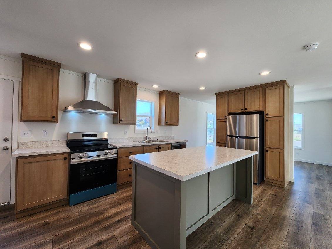 Modern kitchen with island in Johnny B Goode by Clayton Homes with a porch.