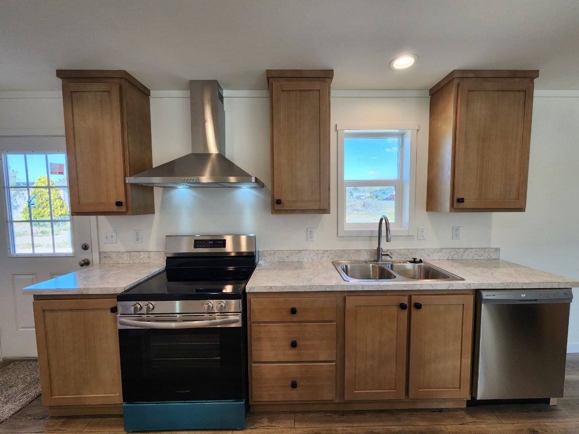 Kitchen with stainless steel appliances in Johnny B Goode by Clayton Homes