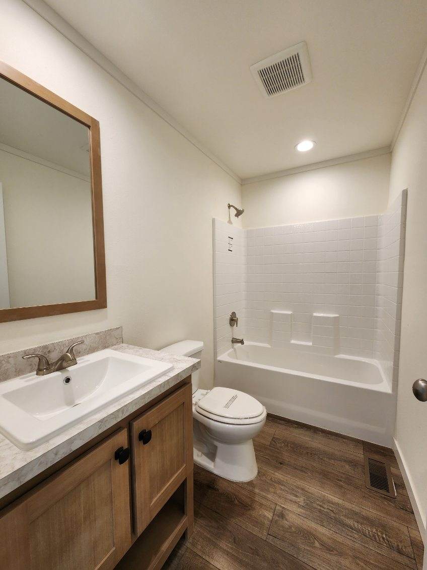 Tub-shower combo in guest bathroom of Johnny B Goode by Clayton Homes