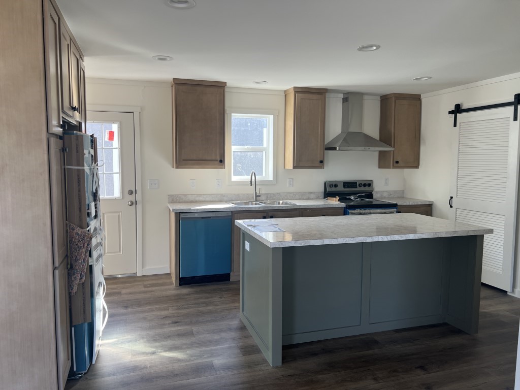 Modern kitchen with island in Tempo Shout by Clayton Homes.