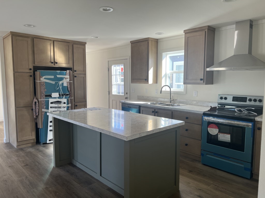 Tempo Shout kitchen features stainless steel appliances in this affordable home