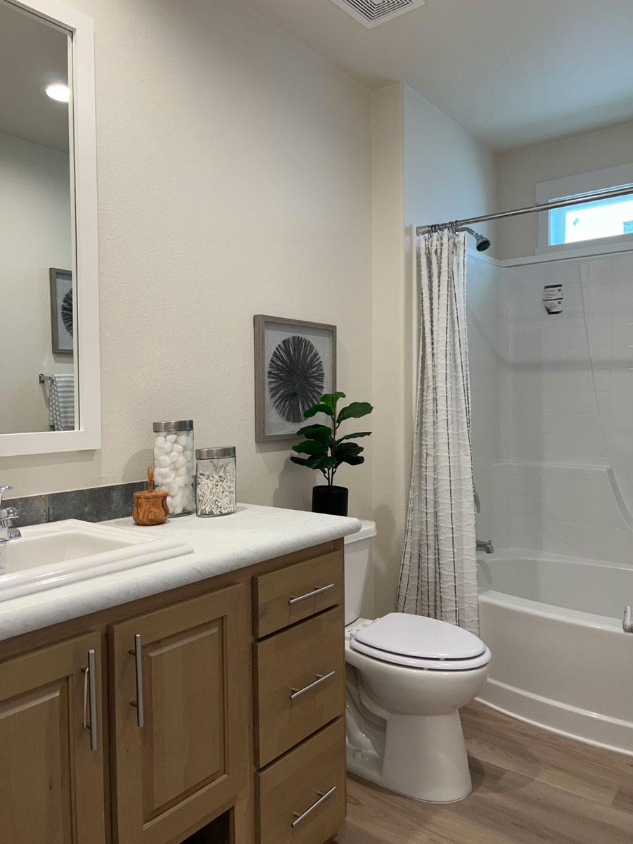 Second bath with warm finishes in the 30684E Fleetwood home